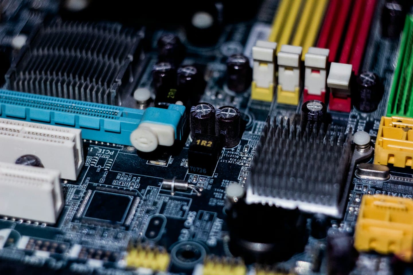 Intricate circuitry and colorful components on a computer motherboard.